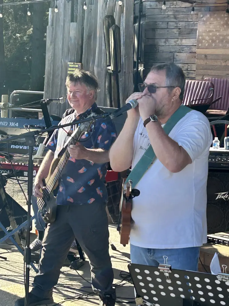 Guitarist singing beside the bass player