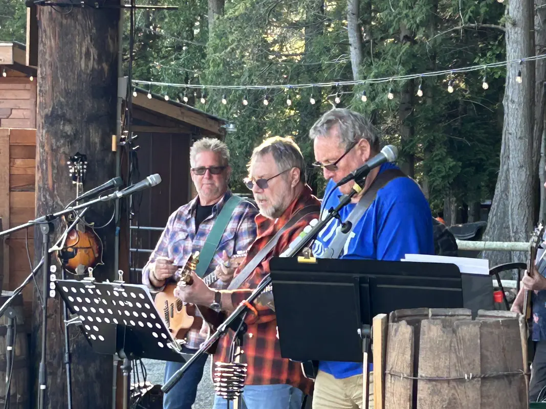 Three guitarists lined up at the mics