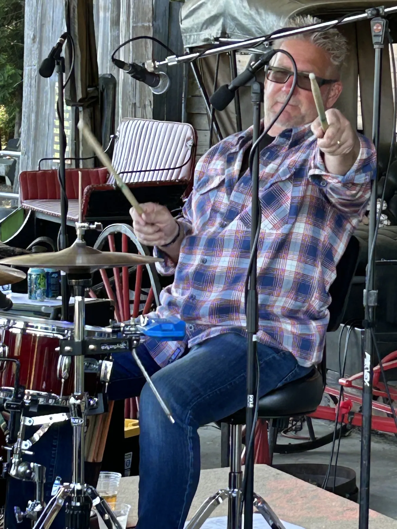 Woody pointing a drumstick at the crowd
