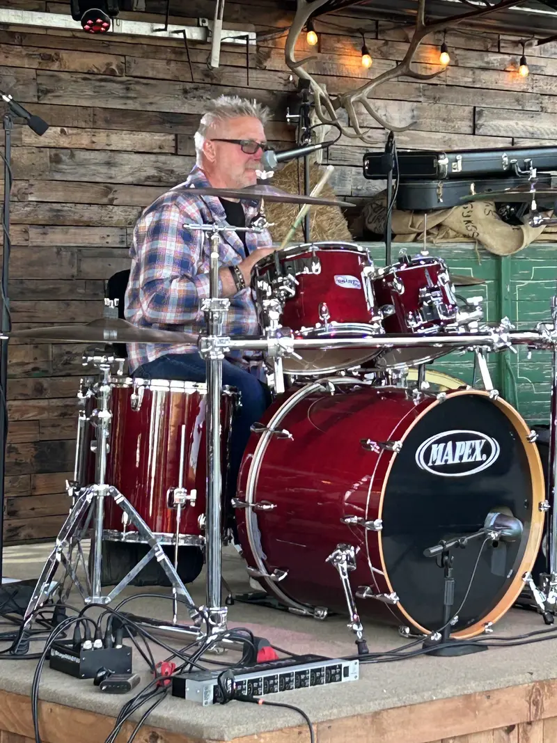 Woody behind the red drum kit