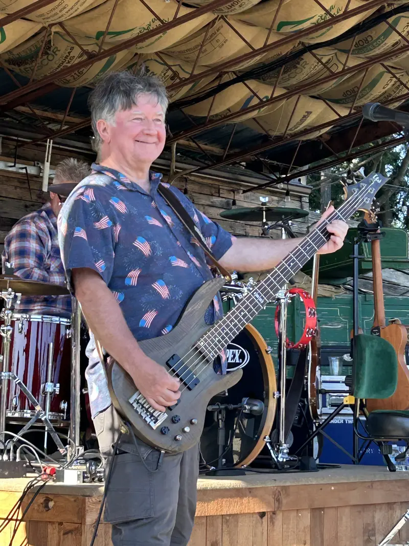 Richard grinning on bass