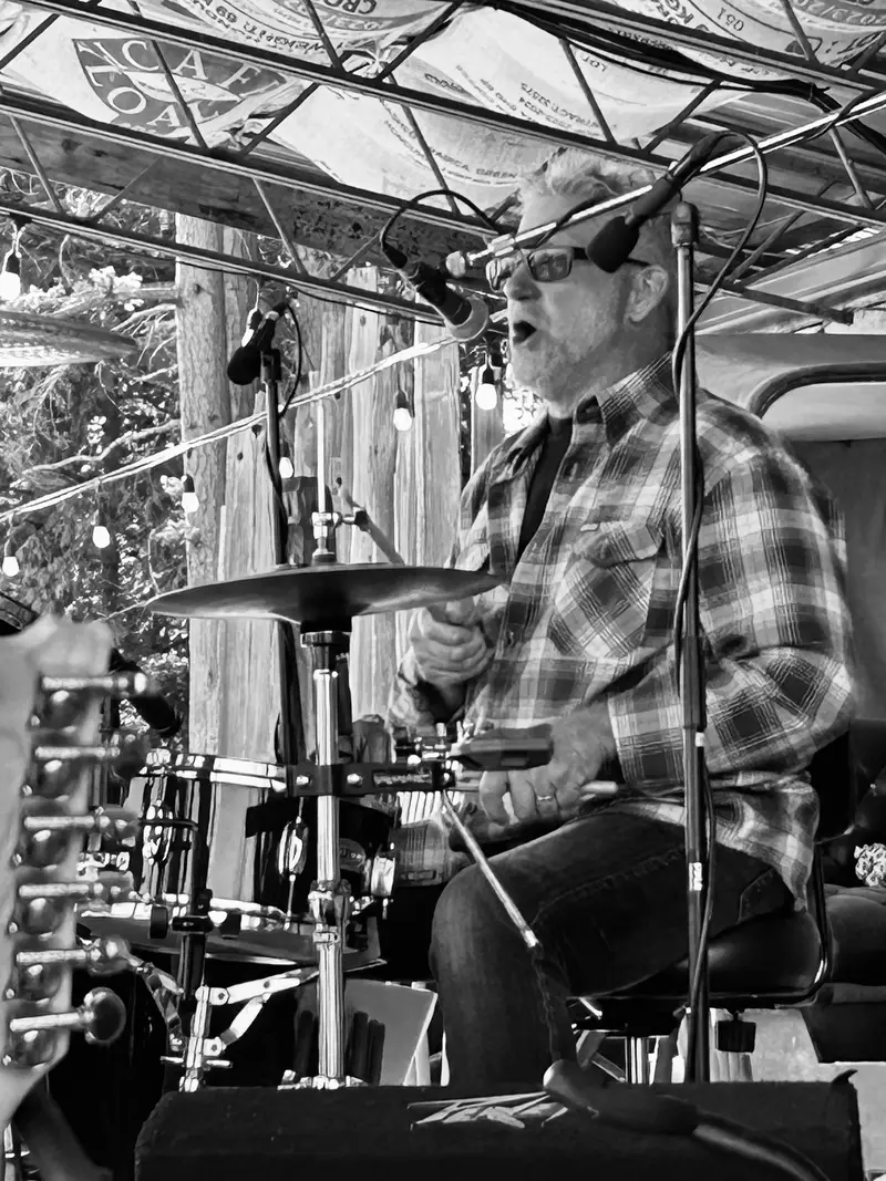 Drummer singing behind the kit